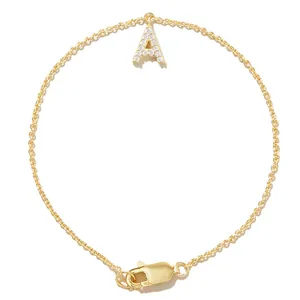 Detailed macro view of a gold-plated initial 'A' bracelet featuring sparkling zircon stones