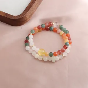 Detail view of a double-strand beaded bracelet with multi-color natural gemstones.
