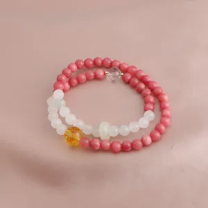 Detail view of a double-strand beaded bracelet with pink and white natural gemstones