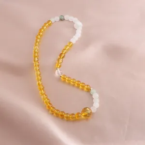 Detail showing the vibrant citrine and white quartz beads of this Chinese style bracelet
