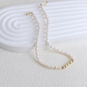 Detail view of elegant freshwater pearl necklace with polished gold bead accents