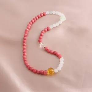 Close-up of New Chinese style beaded bracelet with pink and yellow gemstones on silk