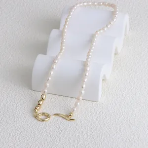 Detailed view of freshwater pearl necklace with elegant gold OT clasp and bean accents