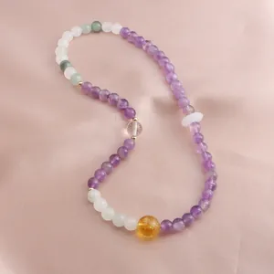 Detailed view of mixed gemstone beaded bracelet featuring amethyst and citrine stones.