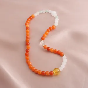 Close-up detail of a multi-layer bead bracelet featuring natural citrine and golden silk jade stones