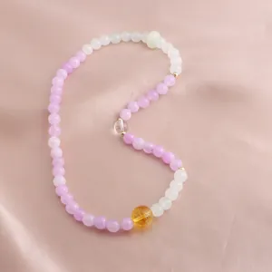 Macro detail of a new Chinese style beaded bracelet with purple kunzite and yellow citrine.