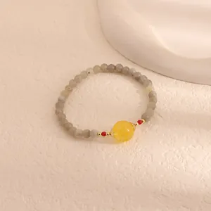 Detailed macro view of an elegant moonstone and citrine bead bracelet with gold accents