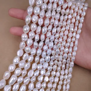 Close-up of multiple strands of irregular white baroque freshwater pearls for DIY jewelry.