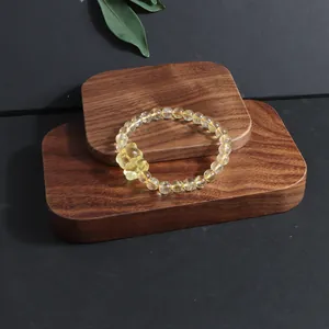 Detailed shot of a natural yellow citrine beaded bracelet featuring a nine-tailed fox charm
