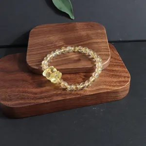 Close-up of a natural yellow citrine bracelet with a nine-tailed fox charm