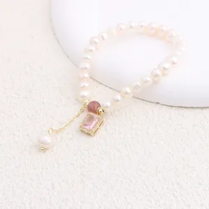 Detailed macro view showing the natural freshwater pearl bracelet with pink zircon pendant