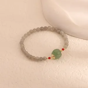Detailed view of moonstone and green chalcedony pumpkin bead bracelet in elegant style