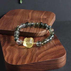 Green phantom crystal beaded bracelet featuring an exquisite yellow lion dance charm