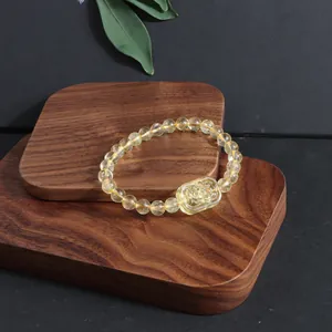 Detailed view of a natural citrine crystal bracelet featuring a carved fox charm