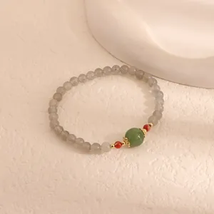 Detailed view of handcrafted Moonstone and green Chalcedony beaded bracelet with Agate.