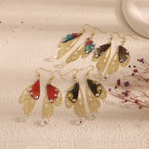Handmade cicada wing drop earrings with gold filigree and colorful butterfly patterns