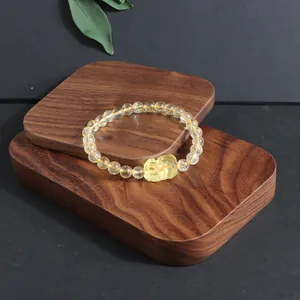 Macro view of natural citrine crystal bracelet featuring a carved Pixiu charm.