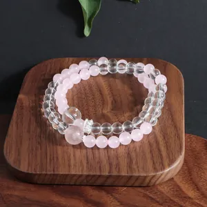 Close-up detail of double-strand natural crystal beaded bracelet on wooden display