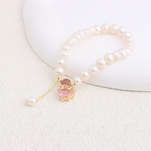 Macro view of natural freshwater pearl bracelet with faceted pink heart crystal pendant