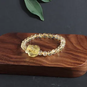 Detailed view of carved Nine-Tailed Fox charm on natural citrine bracelet