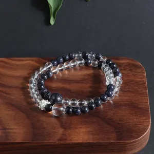 Detailed close-up of double-layered bracelet with blue goldstone and clear crystal beads