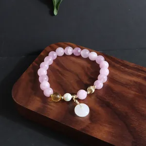 Nahaufnahme eines neuen chinesischen Armbands mit lila Perlen und weißem Jadepenant