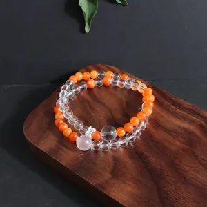 Detailed view of the double-layer natural crystal bracelet on a wooden tray