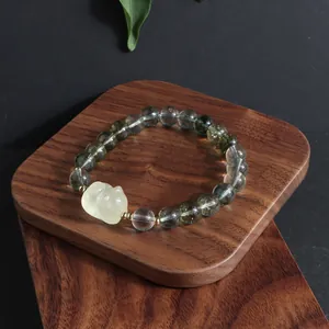 Green phantom crystal beaded bracelet with carved lemon yellow lucky cat charm