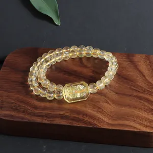 Macro view showing the translucent natural citrine beads and the intricate floral carving detail