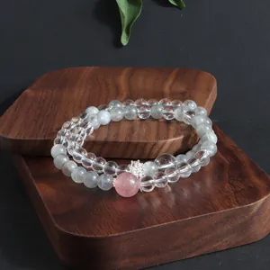 Detail view of a double-layered natural stone bracelet with crystal and rose quartz