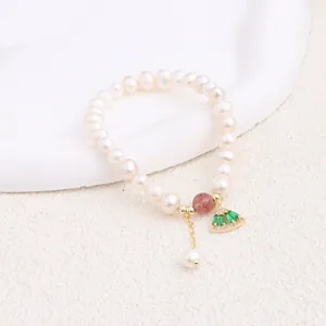 Detailed view of natural freshwater pearl bracelet with green fan-shaped charm and bead