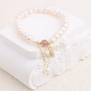 Close-up of freshwater pearl bracelet with exquisite zircon-studded bee pendant detail