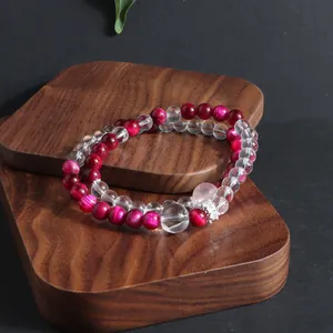 Macro detail of natural rose red tiger eye and clear quartz double-layered crystal bracelet