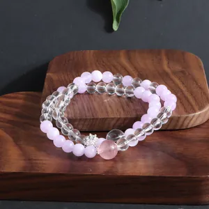 Detail view of double-layer pink and clear crystal beaded bracelet on wood.