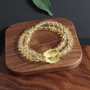 Close-up detail of natural citrine quartz beads and hand-carved fox pendant jewelry