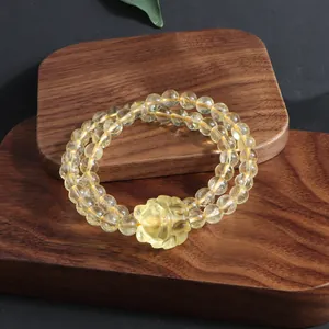 Detailed view of a natural citrine double-strand bracelet with a carved Pixiu charm