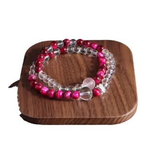 Elegant double-layered fuchsia tiger eye and clear crystal bead bracelet on wooden display