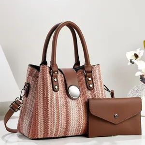 Detail view of the 2-piece handbag set including a woven tote and matching brown pouch