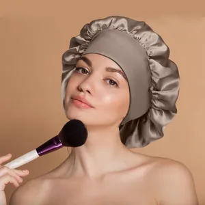 Detail view of smooth satin sleep cap on model with makeup brush