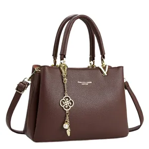 Elegant brown leather handbag with clover charm for daily commuting and fashion.