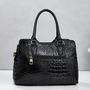 Detail view of the black crocodile embossed handbag showing the gold back zipper pocket.