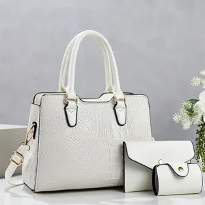 Stylish three-piece white bag set featuring crocodile texture tote and matching accessory pouches