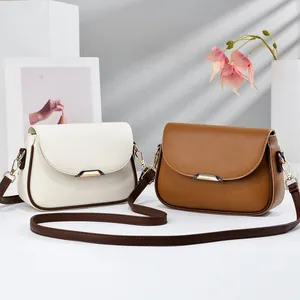 Minimalist solid color shoulder bags in cream and brown with gold hardware accents.