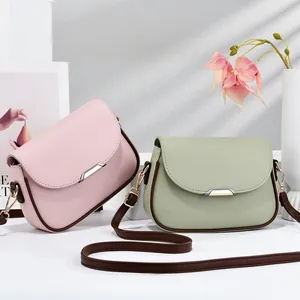 Elegant minimalist small crossbody bags in pink and green with flap closure detail
