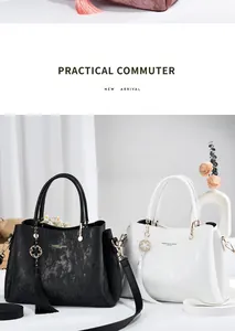 Detailed view of black and white textured leather handbags with elegant tassel charms