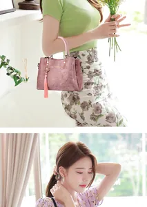 Elegant pink floral patterned handbag with decorative tassel detail carried by a female model