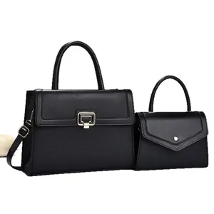 Elegant black two-piece handbag set featuring textured panels and gold-tone hardware