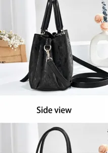 Detailed side view of a black textured leather handbag for women with adjustable strap