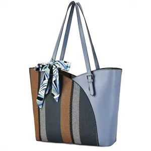 Stylish color block tote bag with striped woven detail and blue scarf ornament