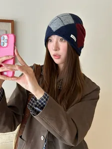 Close-up of a stylish vintage argyle knitted beanie worn by a model in a selfie